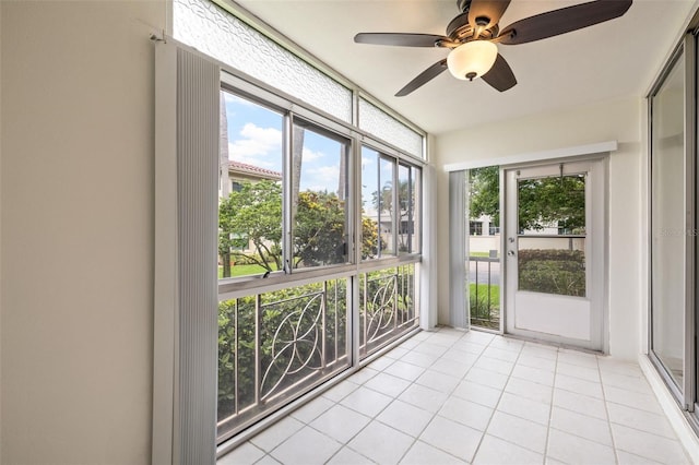 unfurnished sunroom with ceiling fan