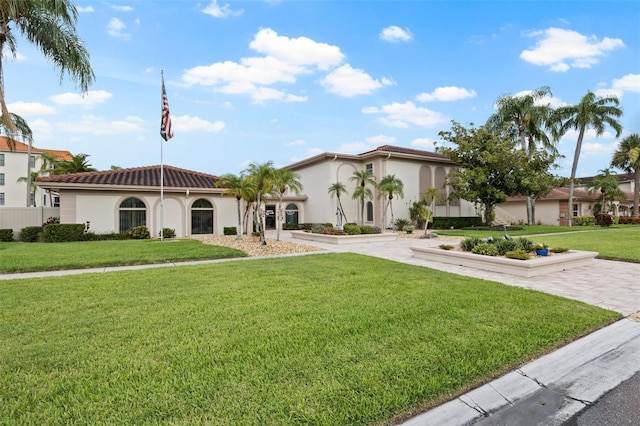 mediterranean / spanish-style house featuring a front lawn