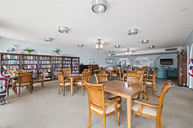 dining room with a textured ceiling and ceiling fan