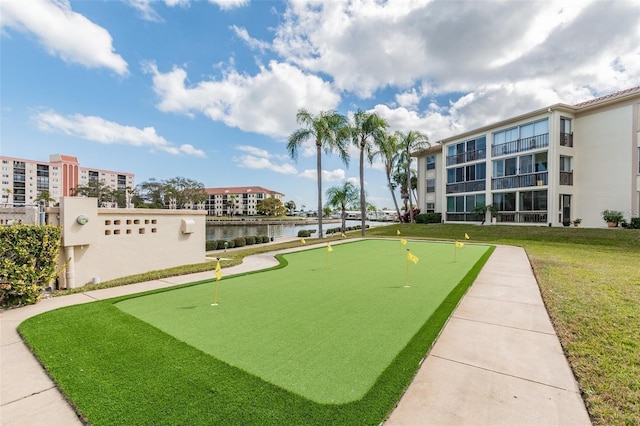 view of community featuring a water view and a lawn