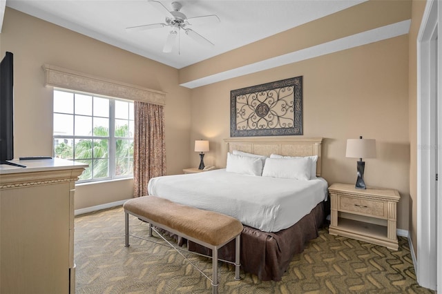 bedroom with dark colored carpet and ceiling fan