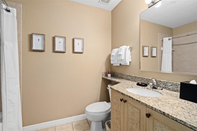 bathroom featuring tile patterned flooring, vanity, toilet, and curtained shower