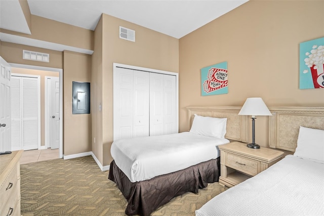 bedroom featuring carpet, electric panel, and a closet