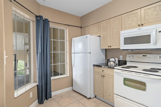 kitchen with white appliances and light tile patterned floors