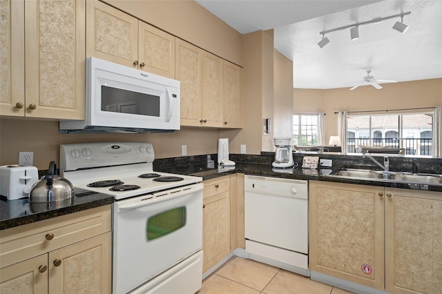 kitchen featuring sink, rail lighting, a textured ceiling, white appliances, and light tile patterned flooring