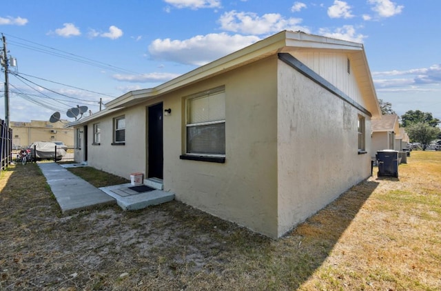 view of property exterior with a yard