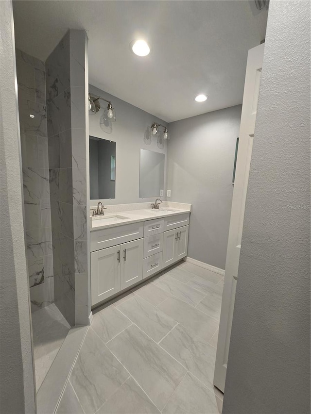 bathroom featuring vanity and tiled shower