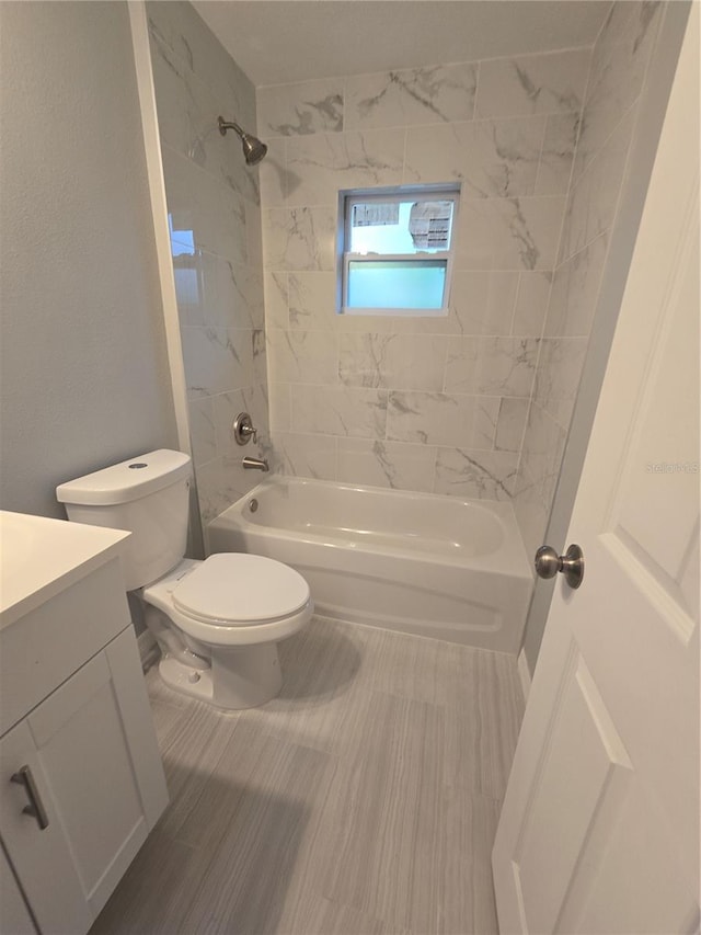 full bathroom featuring vanity, toilet, and tiled shower / bath