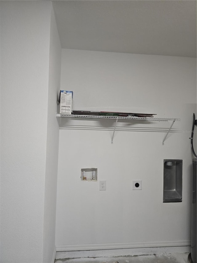 clothes washing area with baseboards, washer hookup, hookup for an electric dryer, and laundry area