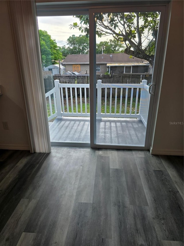 entryway with baseboards and wood finished floors