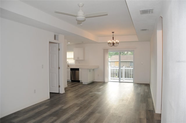 unfurnished living room featuring dark wood-type flooring, a raised ceiling, and visible vents