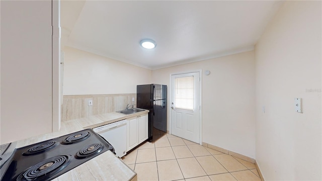 kitchen featuring sink, white cabinetry, black refrigerator, white dishwasher, and range with electric cooktop