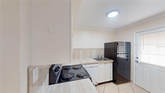 kitchen with electric stove, sink, light tile patterned floors, dishwasher, and black fridge