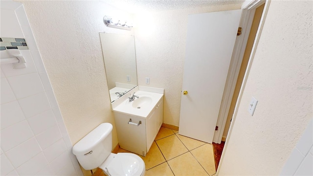 bathroom with vanity, tile patterned flooring, and toilet