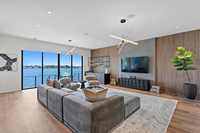 living room with light wood-type flooring and an inviting chandelier