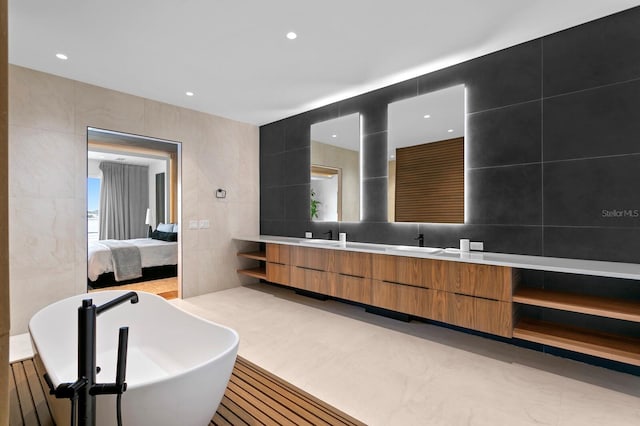 bathroom featuring vanity and tile walls