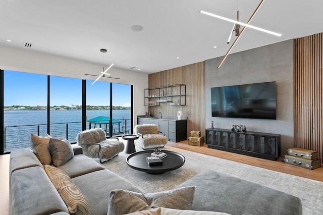 living room with hardwood / wood-style flooring and a water view