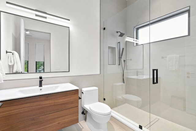 bathroom with tile patterned floors, vanity, toilet, and walk in shower