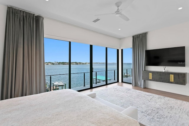 bedroom with access to exterior, ceiling fan, and hardwood / wood-style flooring