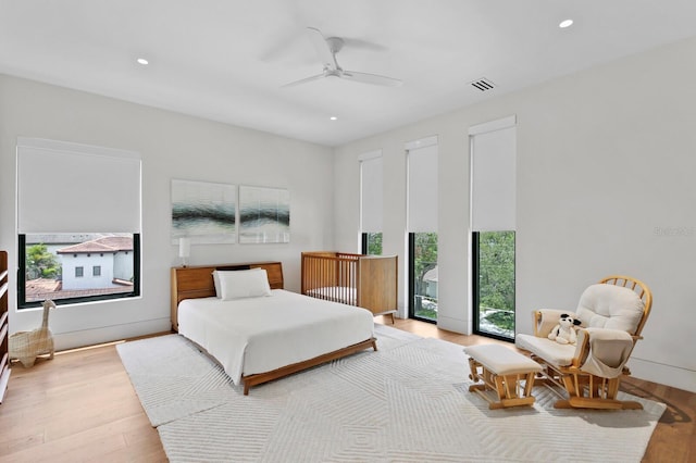 bedroom featuring ceiling fan, access to exterior, and light wood-type flooring