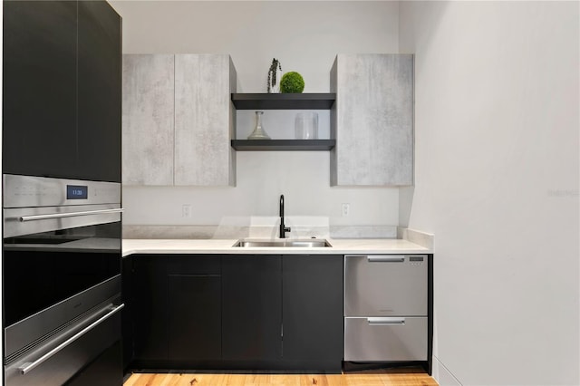 kitchen featuring sink, stainless steel appliances, and light hardwood / wood-style flooring