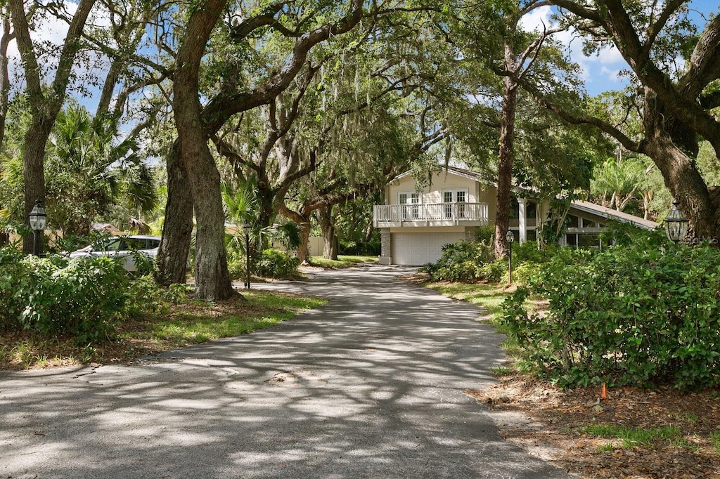 view of front of home featuring a garage and a balcony