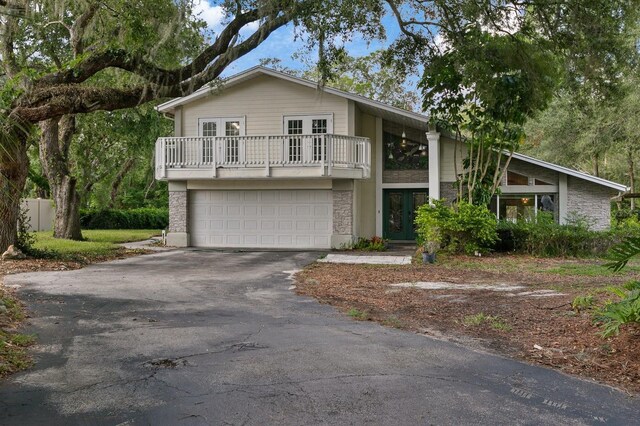 view of front of property with a garage and a balcony