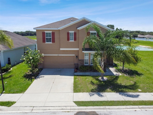 view of front of property with a front lawn and a garage