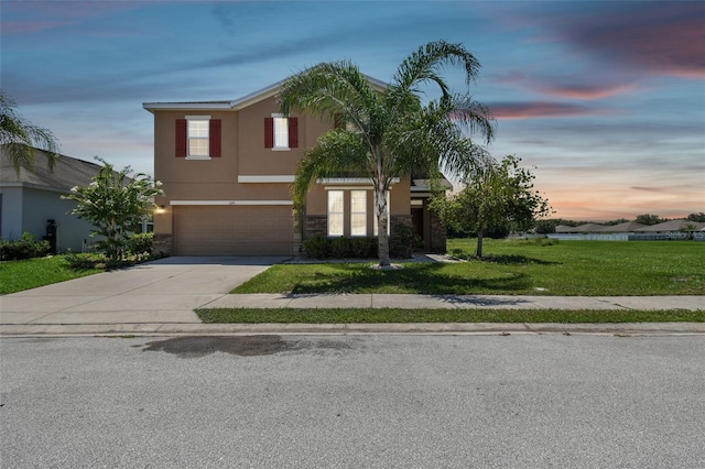 view of front of property featuring a garage and a yard