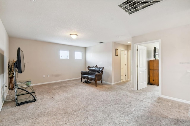 sitting room featuring light colored carpet