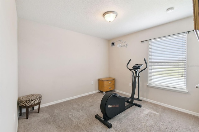 exercise room with light colored carpet