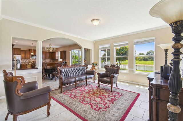 living room featuring an inviting chandelier, light tile patterned flooring, and ornamental molding