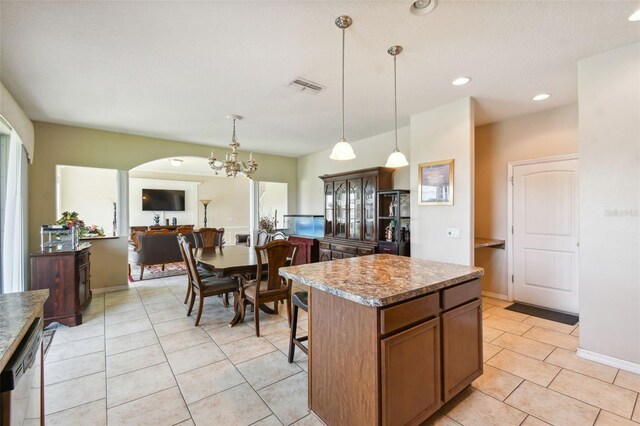 kitchen with pendant lighting, dishwasher, a center island, a notable chandelier, and light tile patterned flooring