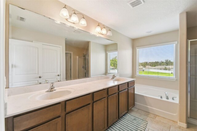 bathroom featuring tile patterned floors, vanity, and shower with separate bathtub