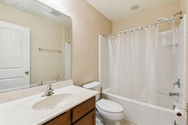 full bathroom featuring shower / bath combo, vanity, a textured ceiling, and toilet