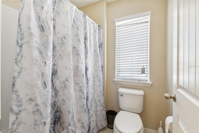 bathroom featuring toilet and walk in shower