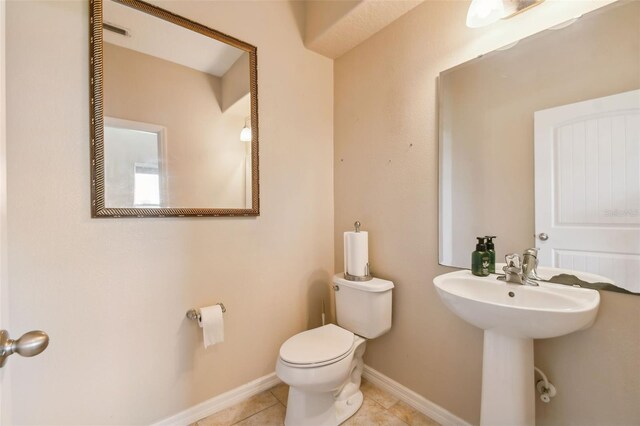 bathroom with tile patterned floors, sink, and toilet