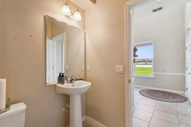 bathroom featuring tile patterned flooring and toilet