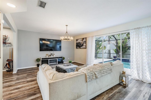 living room featuring a chandelier and dark hardwood / wood-style flooring