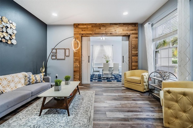 living room featuring wood walls and hardwood / wood-style flooring