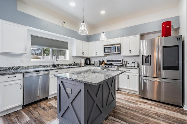 kitchen featuring sink, decorative backsplash, appliances with stainless steel finishes, and wood-type flooring