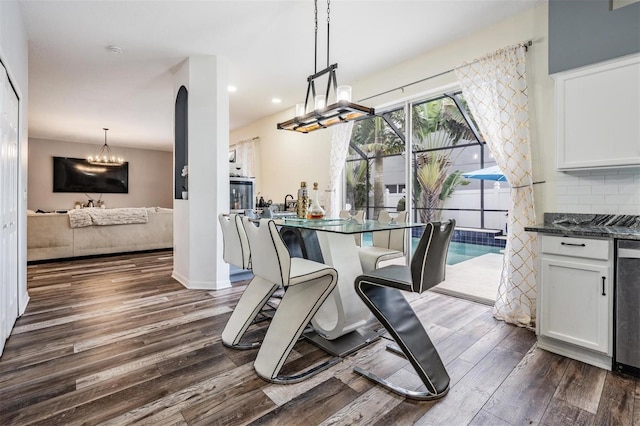 dining room featuring a chandelier and dark wood-type flooring