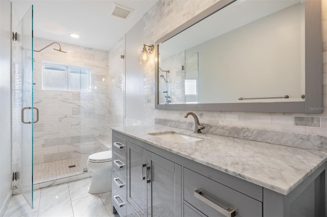 bathroom featuring vanity, tasteful backsplash, toilet, and tile walls