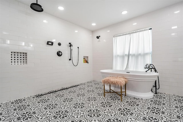 bathroom featuring tiled shower and tile patterned flooring