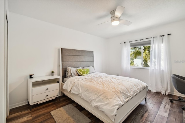 bedroom with dark wood-type flooring and ceiling fan