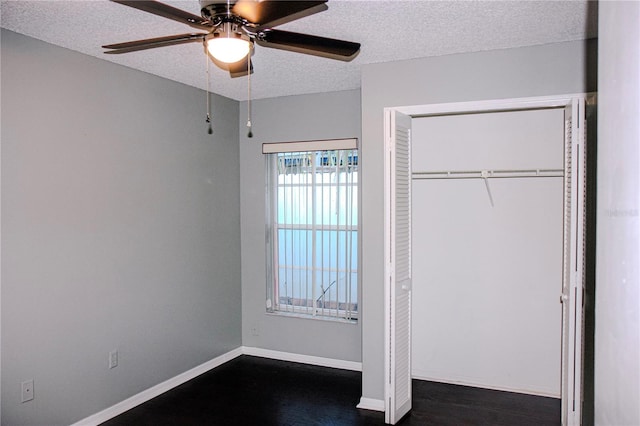 unfurnished bedroom featuring a closet, ceiling fan, and a textured ceiling