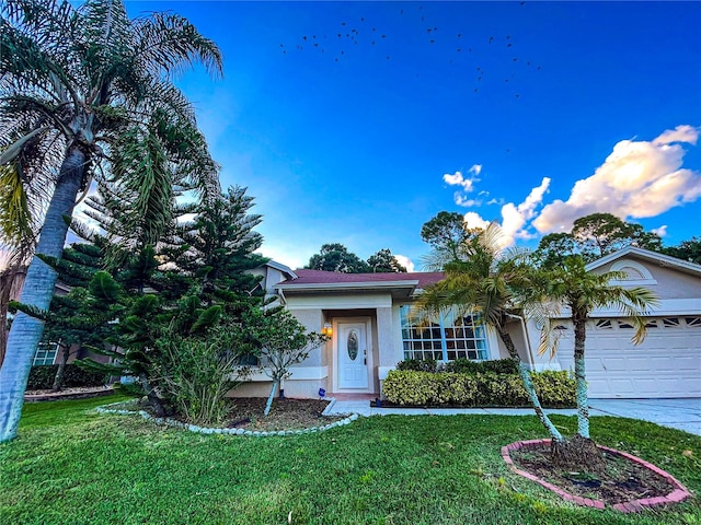 view of property hidden behind natural elements with a front yard and a garage