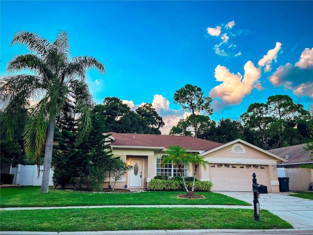 view of front of property featuring a garage and a front lawn