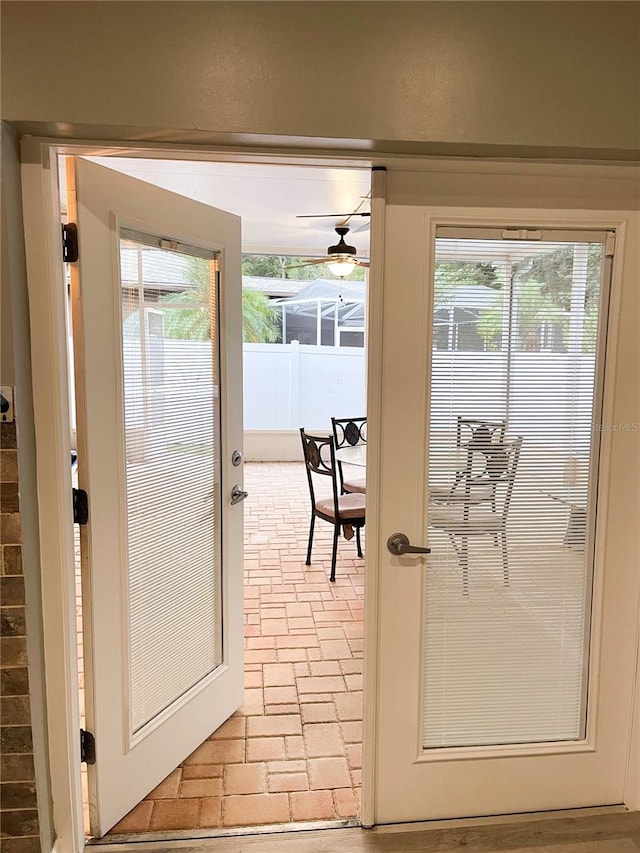 doorway featuring a healthy amount of sunlight and ceiling fan