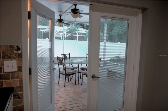 doorway to outside featuring ceiling fan